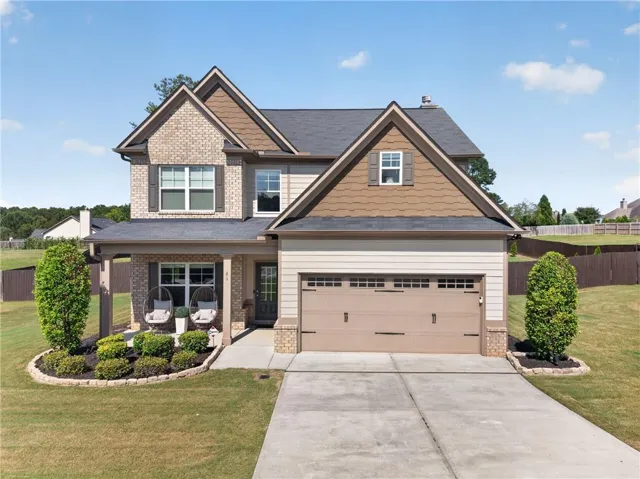 Traditional two-story residence with a brick and siding facade