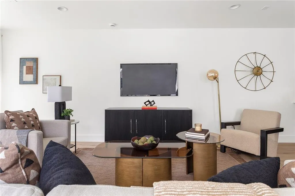 Living area featuring wood finished floors and recessed lighting