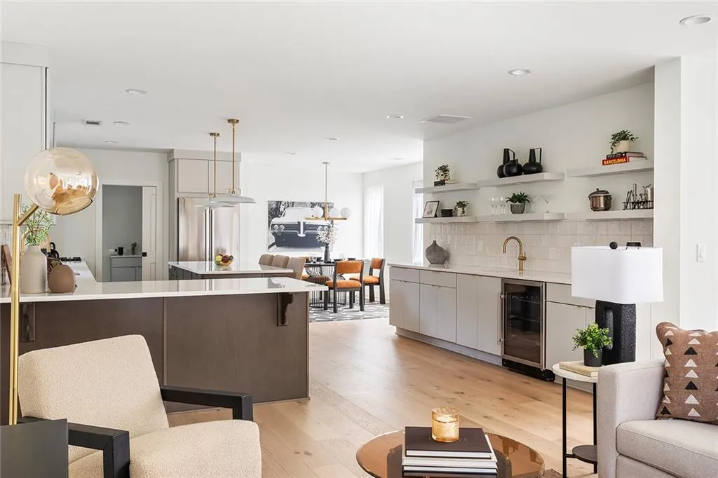Living area featuring light wood finished floors, beverage cooler, and recessed lighting
