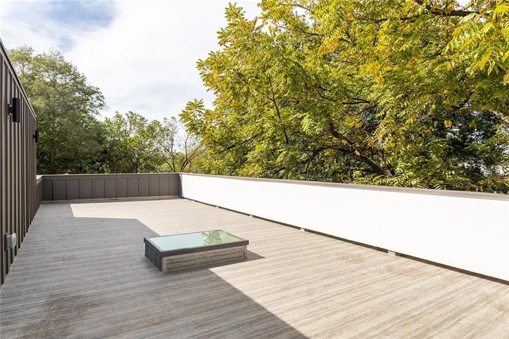 Wooden deck featuring view of wooded area