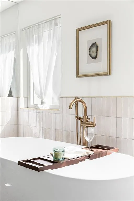 Bathroom view of a sink and tile walls