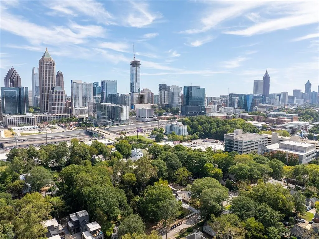 View of city skyline featuring a tree filled landscape