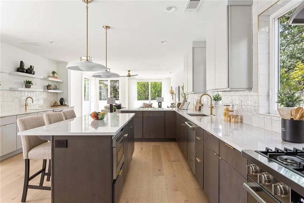 Kitchen with backsplash, a kitchen bar, dark brown cabinets, healthy amount of natural light, and recessed lighting