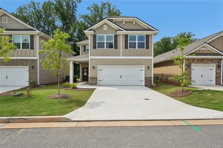 Contemporary exterior with a covered entry, attached single-car garage, and a concrete driveway