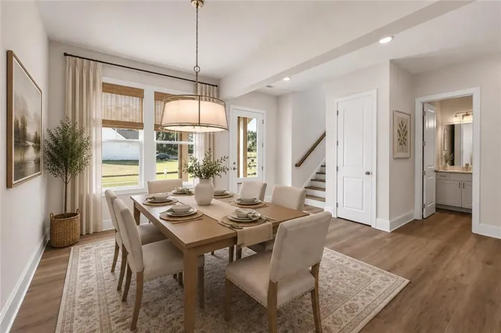 Bathed in natural light, the dining area flows effortlessly into the great room, offering a warm and welcoming setting for gatherings with family and friends.