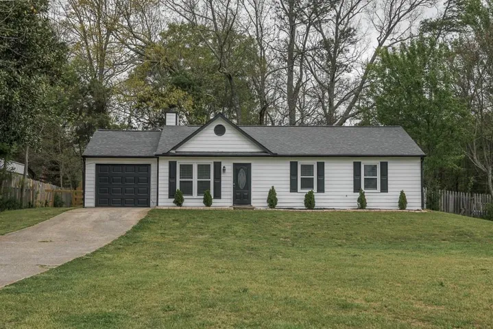 White siding exterior with a dark shingle roof