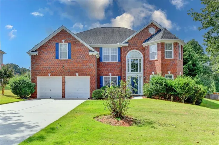 Brick exterior with a prominent arched window entryway