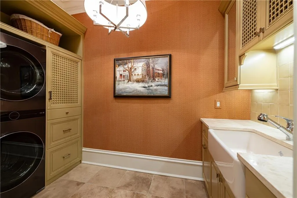 ample cabinetry, built in ironing board, large sink