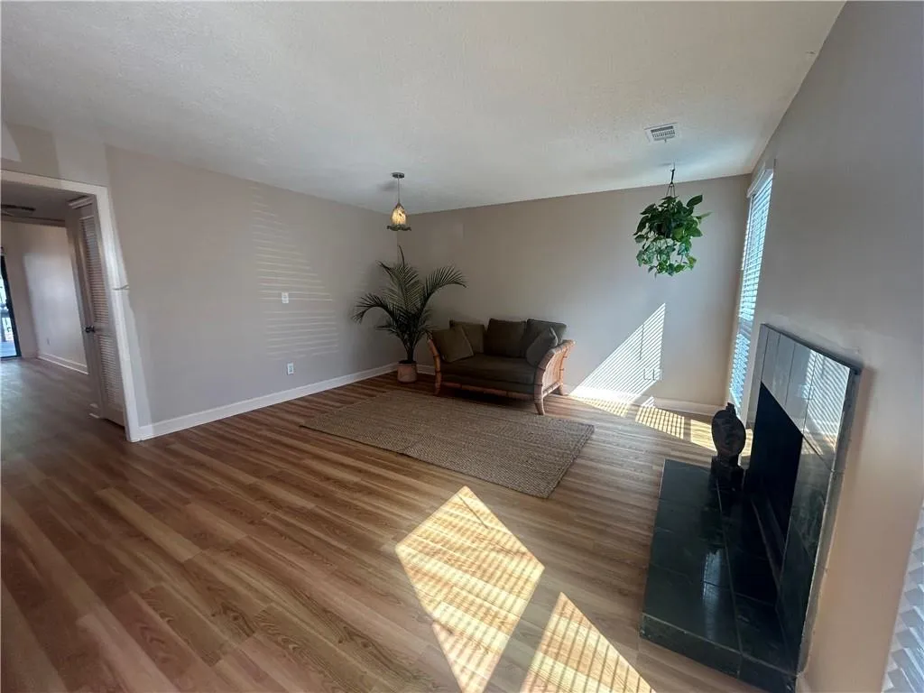 open and bright living room with fireplace