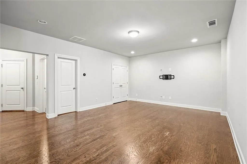 Unfurnished room featuring recessed lighting and dark wood-type flooring