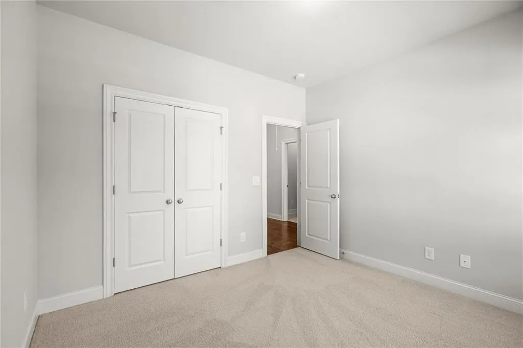 Unfurnished bedroom featuring carpet and a closet