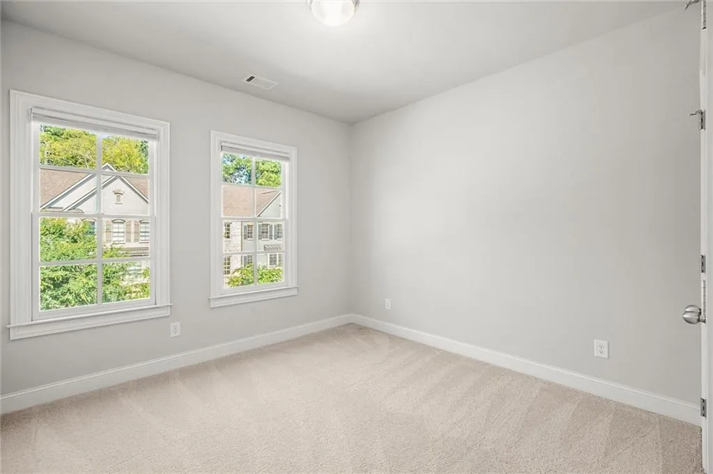 Carpeted empty room featuring baseboards