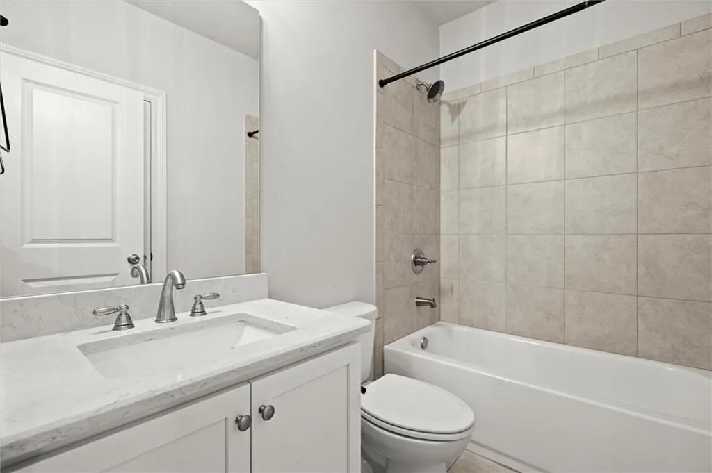 Bathroom with vanity and tub / shower combination