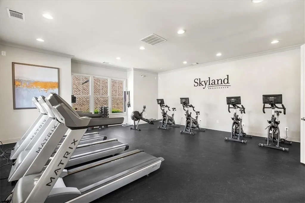 Workout area featuring crown molding and recessed lighting