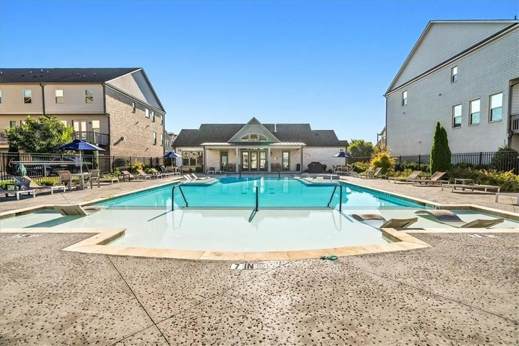 Community pool featuring a patio