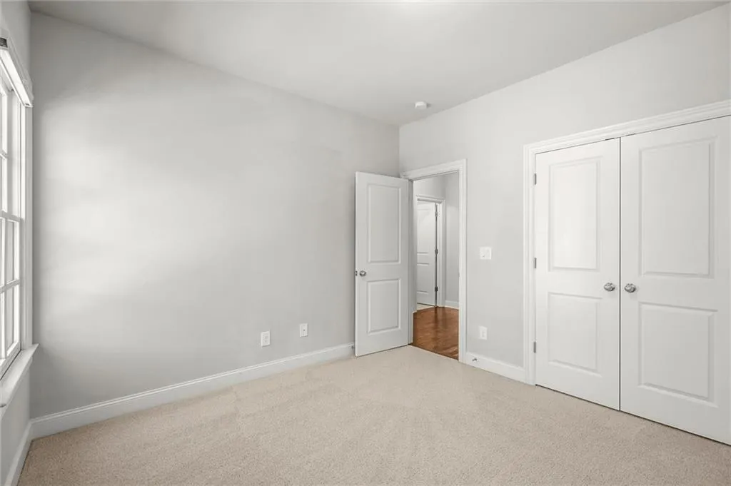 Unfurnished bedroom featuring carpet floors and a closet