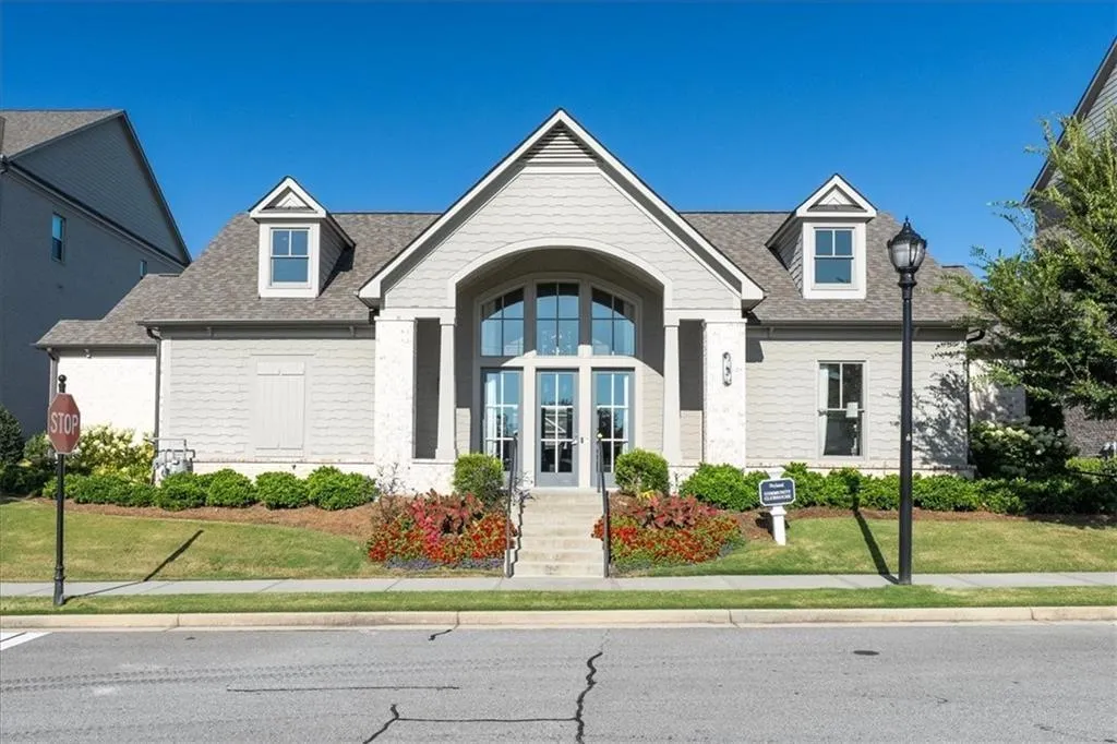 View of front of house with french doors, roof with shingles, and a front yard