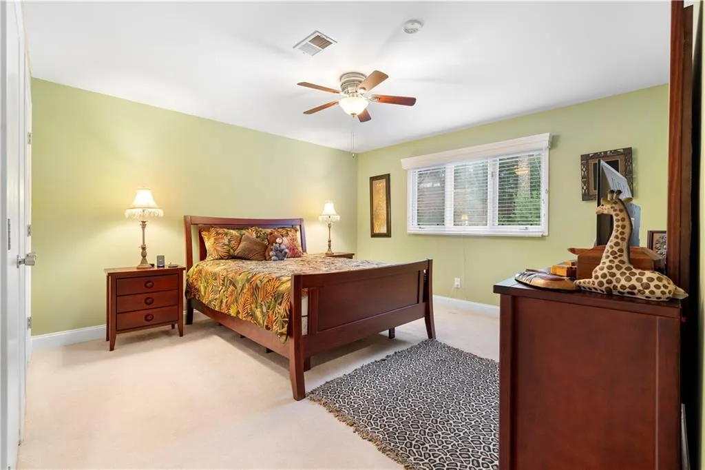 Bedroom featuring light carpet and ceiling fan