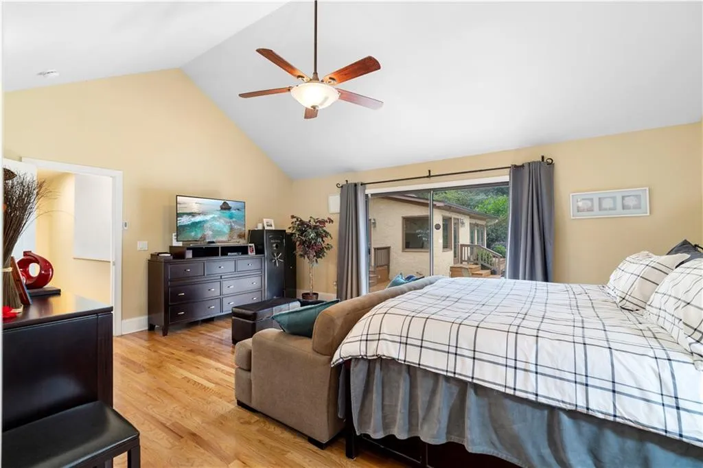 Main Bedroom with access to exterior, light wood finished floors, a high ceiling, and ceiling fan