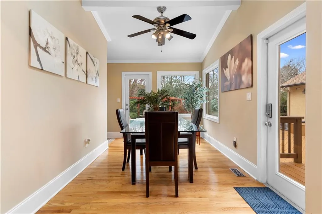 Dining space with crown molding, light wood finished floors, and ceiling fan