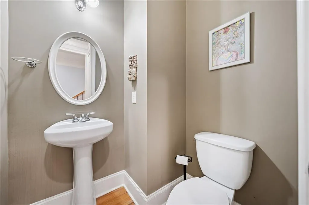 1/2 bathroom on Main level. Bathroom featuring toilet and baseboards