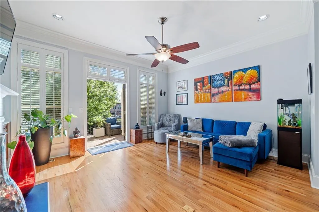Seller utilized space as a Living area with ceiling fan, light wood finished floors, crown molding, recessed lighting, and a fireplace