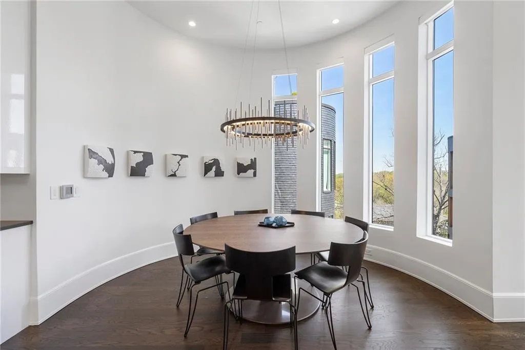 Dining room featuring baseboards, dark wood-style floors, and a wealth of natural light