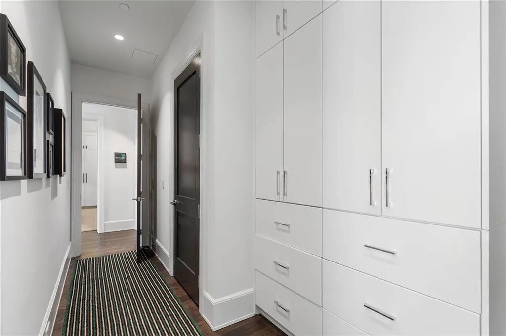 Hall with dark wood-style floors, recessed lighting, and baseboards