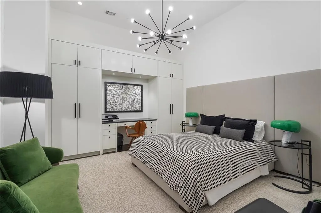 Bedroom with visible vents, a towering ceiling, and a chandelier