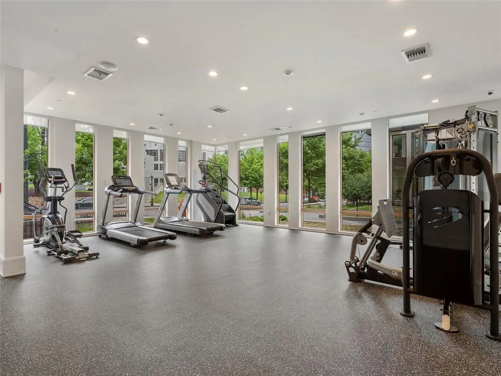 Gym featuring floor to ceiling windows, visible vents, and recessed lighting