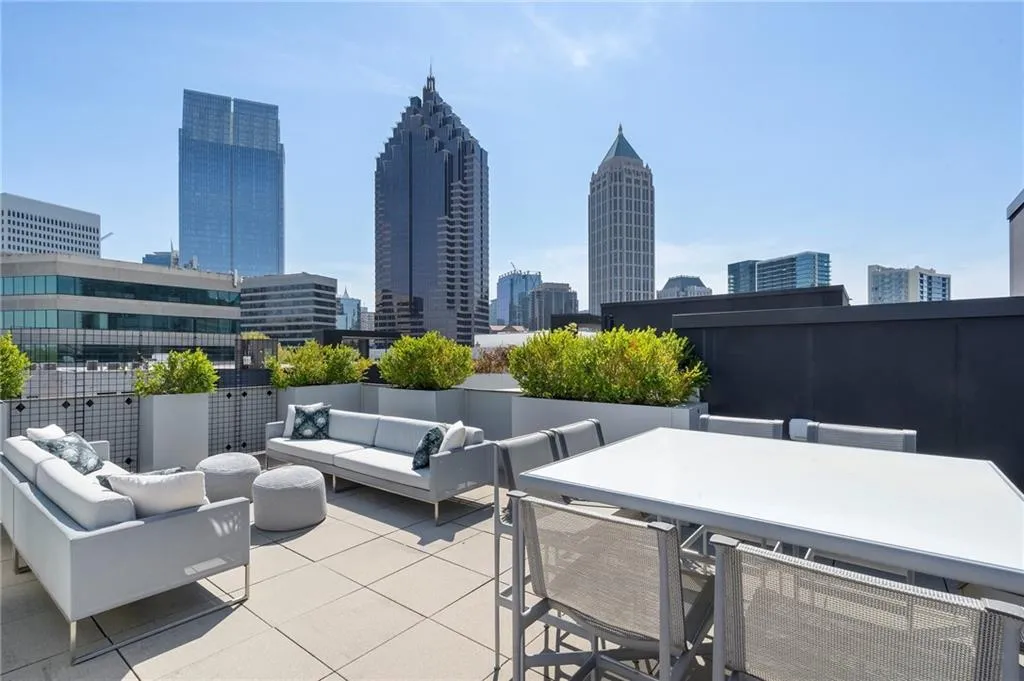 View of patio / terrace featuring a city view, an outdoor living space, and outdoor dining space