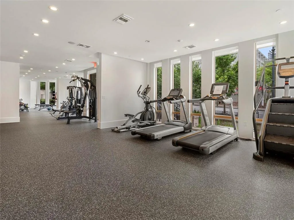Gym with baseboards, visible vents, and recessed lighting