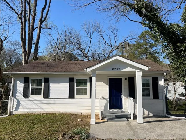View of front of house with roof with shingles
