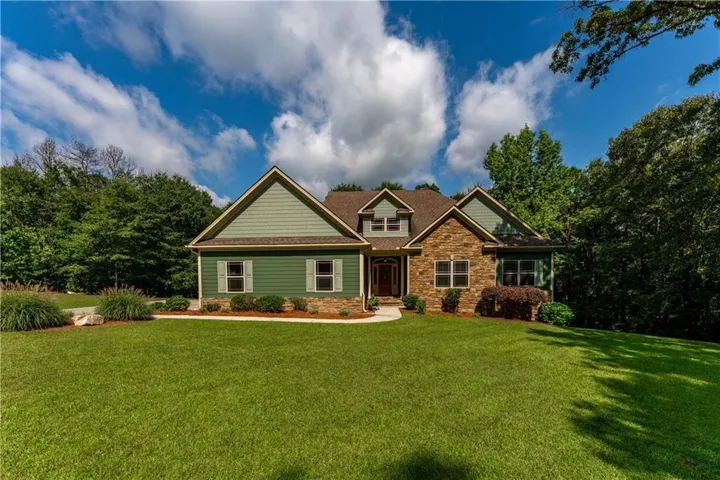 Stone and siding exterior with a prominent gabled roofline