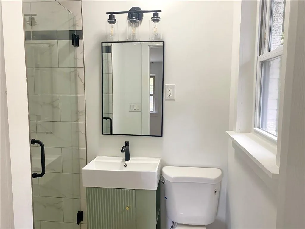 Bathroom with a shower stall, plenty of natural light, and vanity Bathroom with a shower stall, plenty of natural light, and vanity