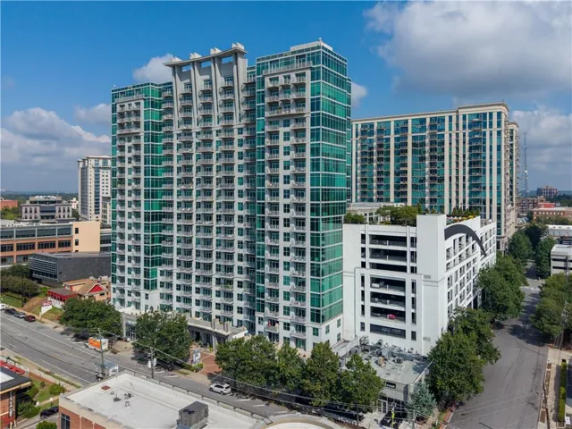 High-rise building featuring extensive glass curtain walls and numerous private balconies
