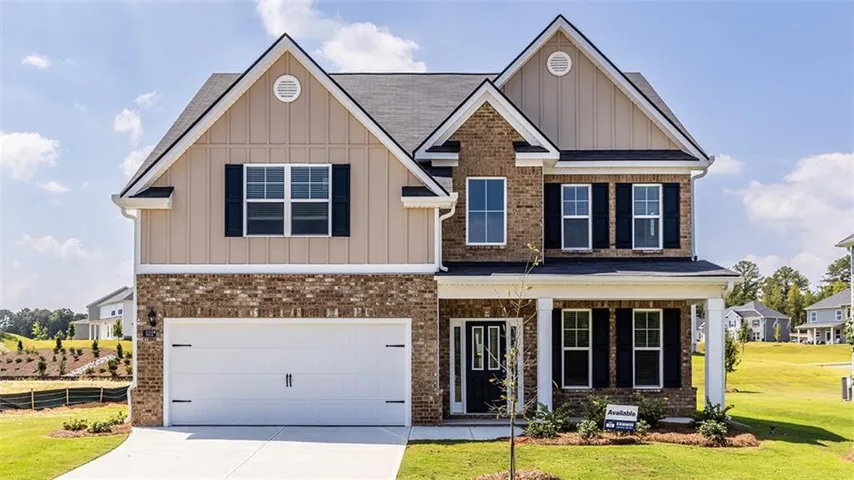 Brick and siding exterior with a covered entry, column accents, a two-car garage, and dark window shutters
