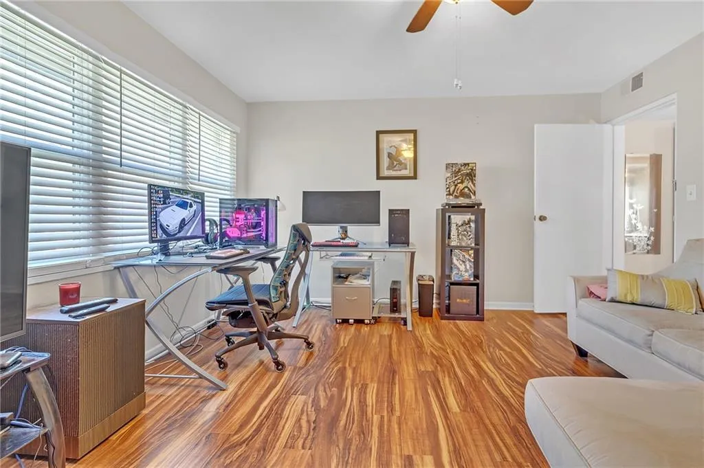 Office with light wood finished floors and ceiling fan