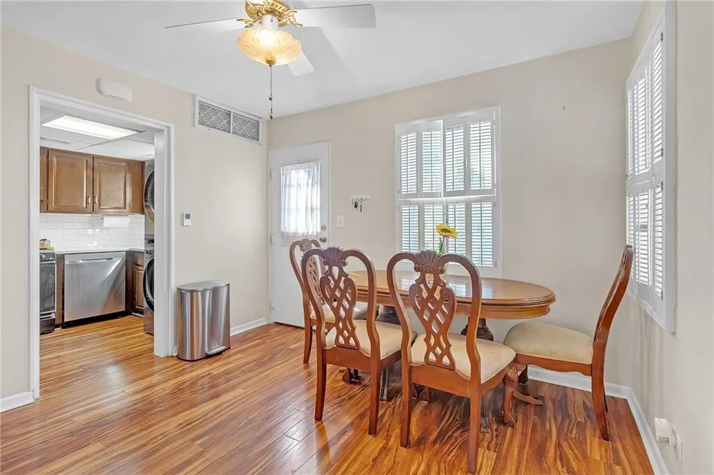Dining area with a ceiling fan, light wood-style floors, and washer / clothes dryer