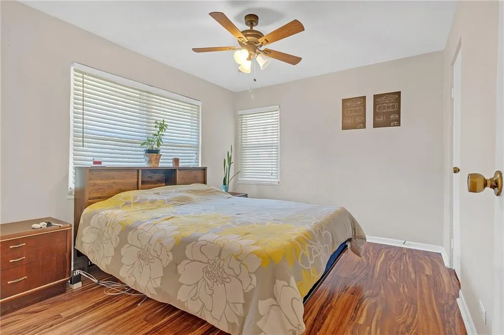 Bedroom featuring wood finished floors and ceiling fan