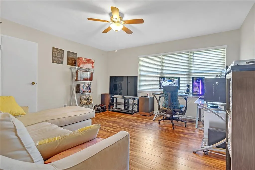 Office area with ceiling fan and hardwood / wood-style flooring