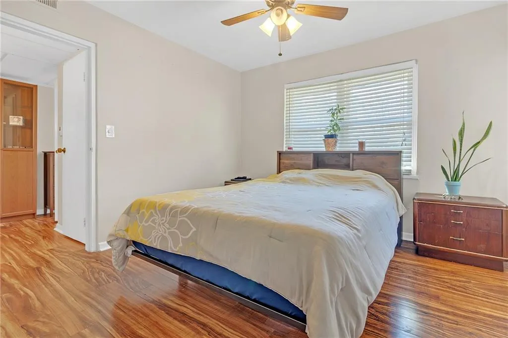 Bedroom with wood finished floors and ceiling fan