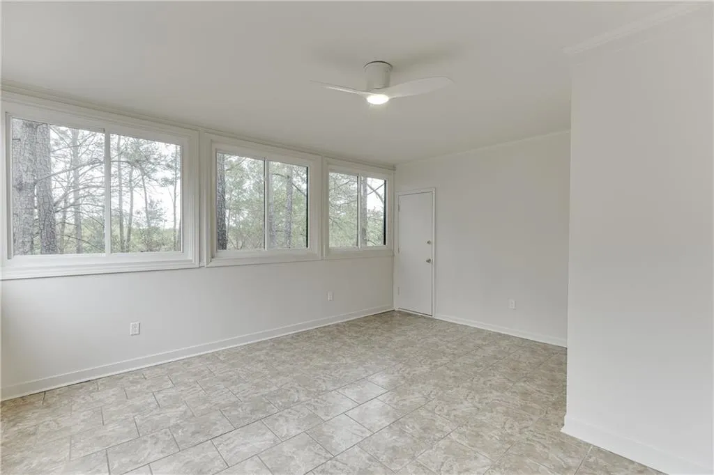 Unfurnished room with baseboards, ceiling fan, and ornamental molding
