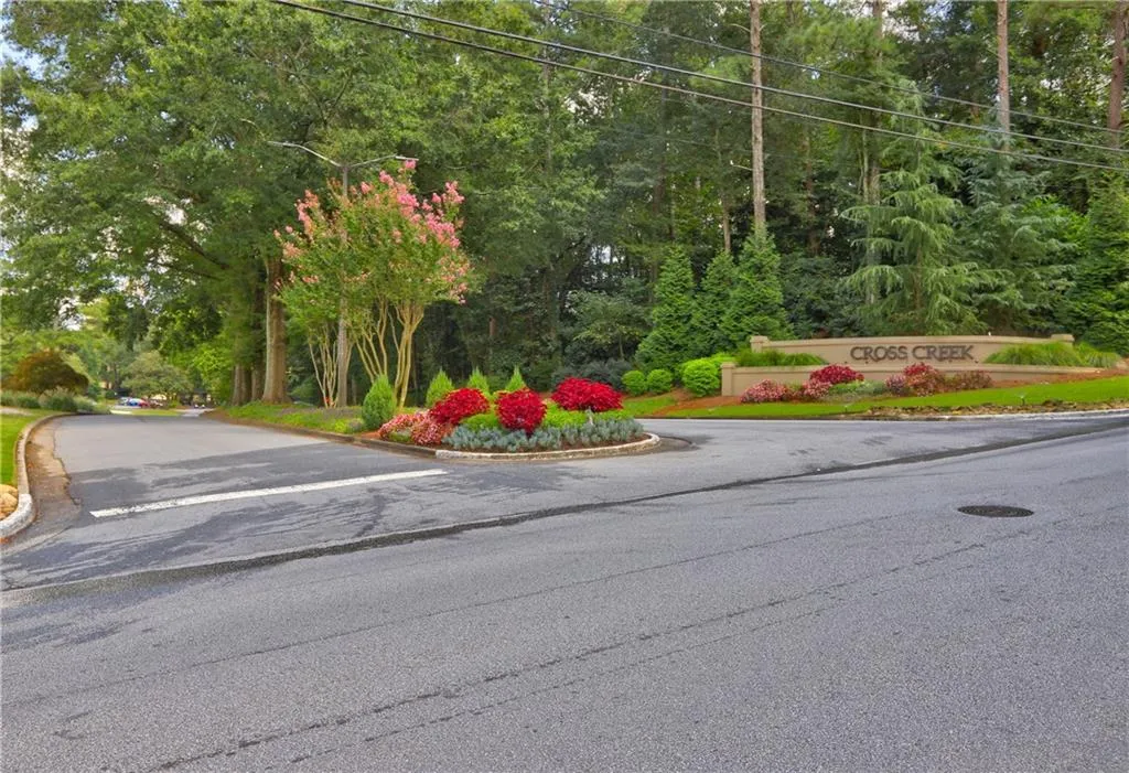 View of asphalt road with curbs and street lighting