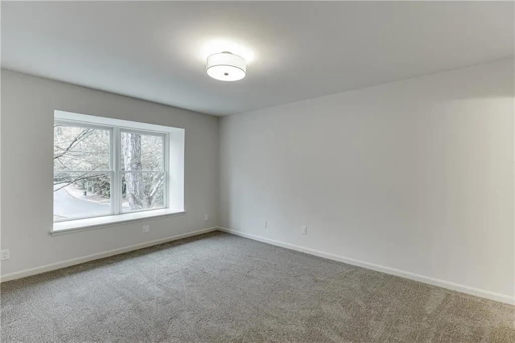 Unfurnished room featuring carpet flooring and baseboards