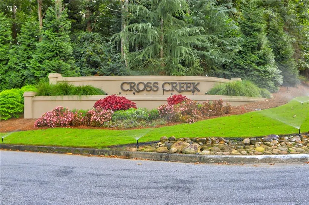 Community / neighborhood sign featuring a yard
