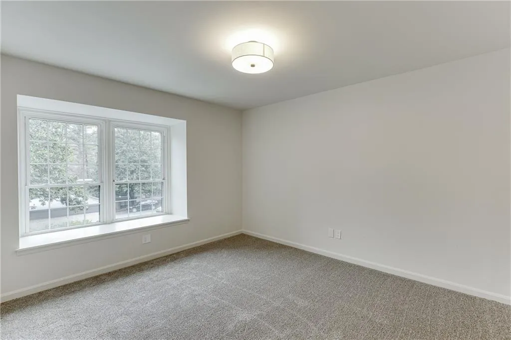 Empty room with baseboards and carpet
