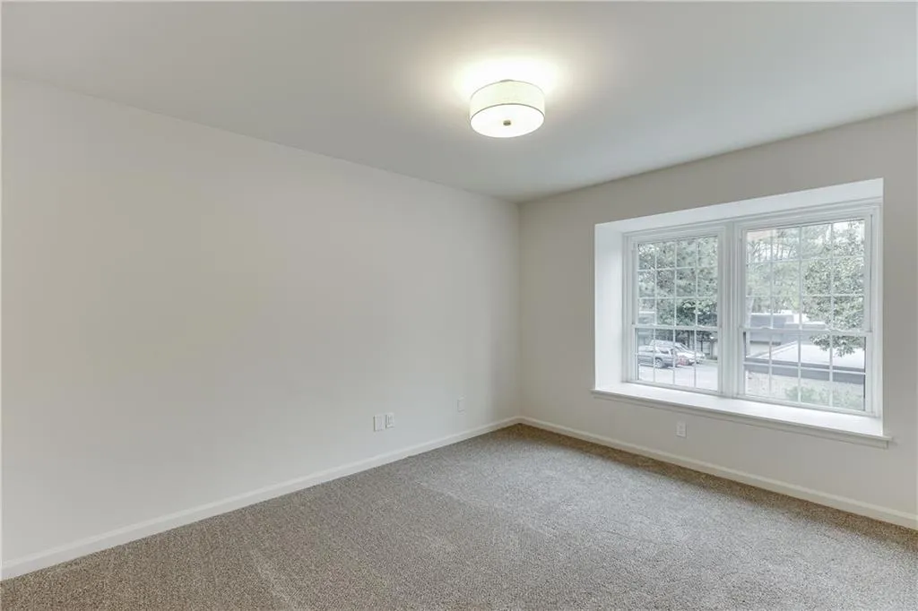 Empty room featuring carpet floors and baseboards