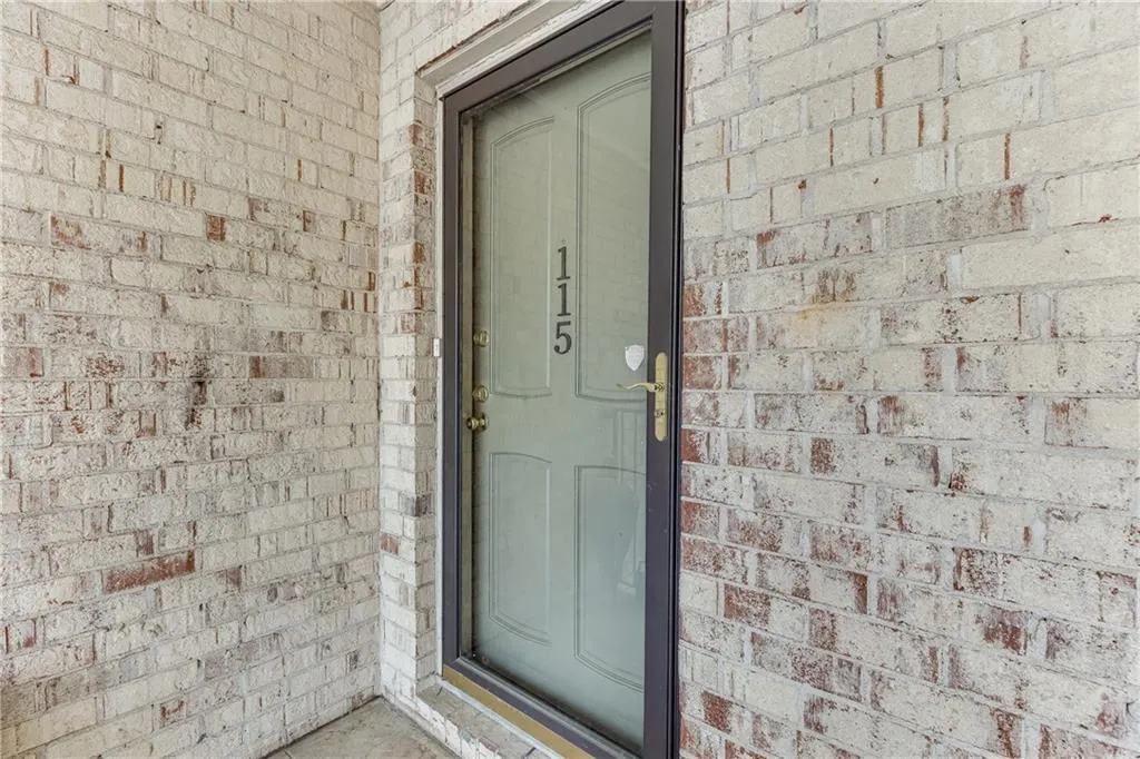 Entrance to property with brick siding