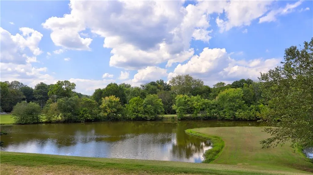 Water view with a heavily wooded area